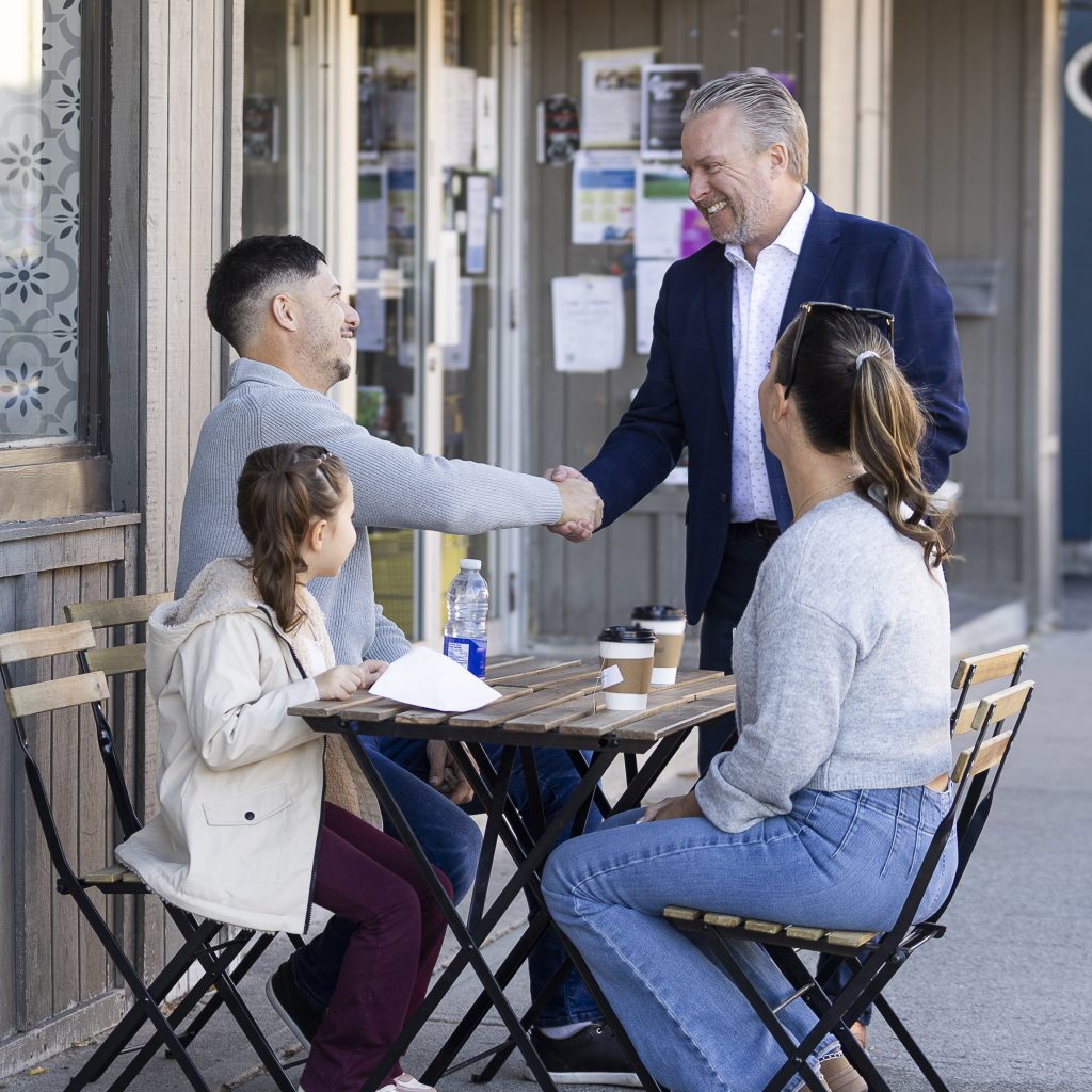 Jason Brass meeting residents in at a local business